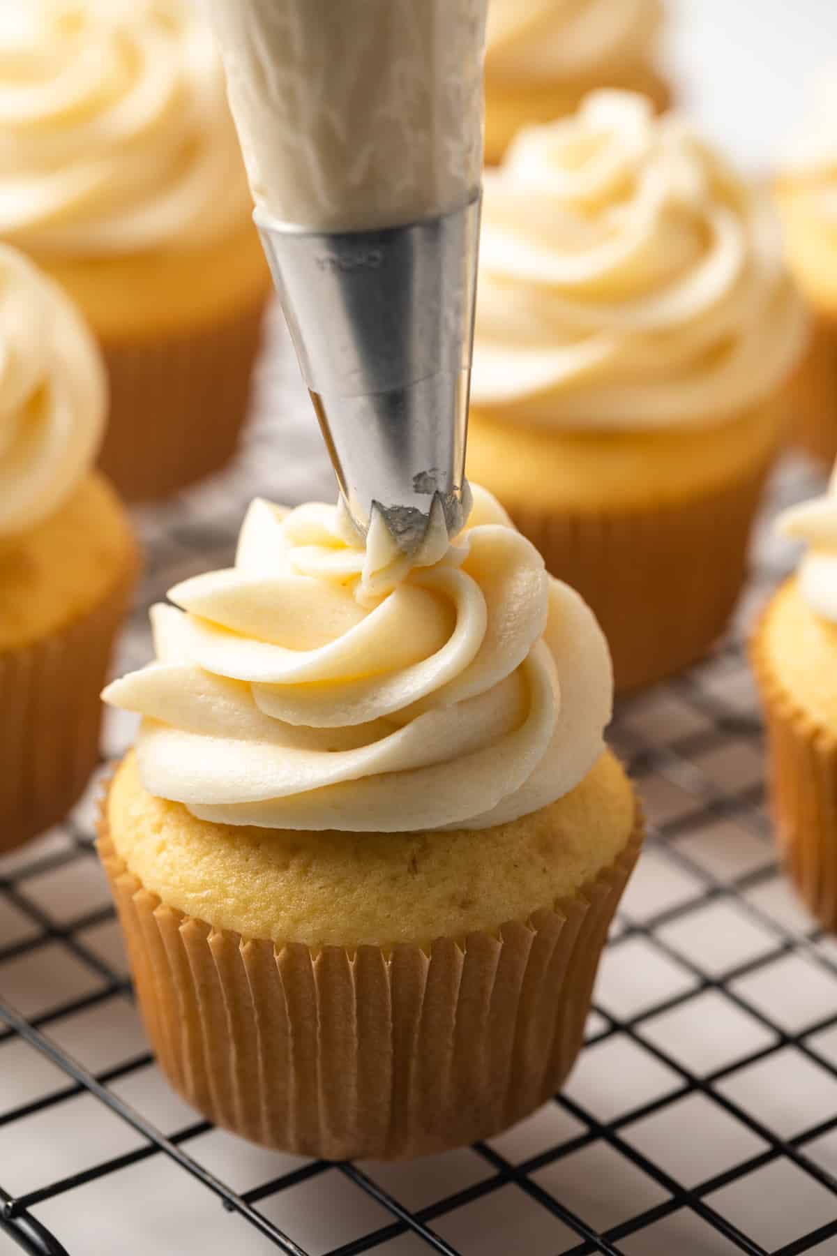 Ermine frosting piped over vanilla cupcakes.