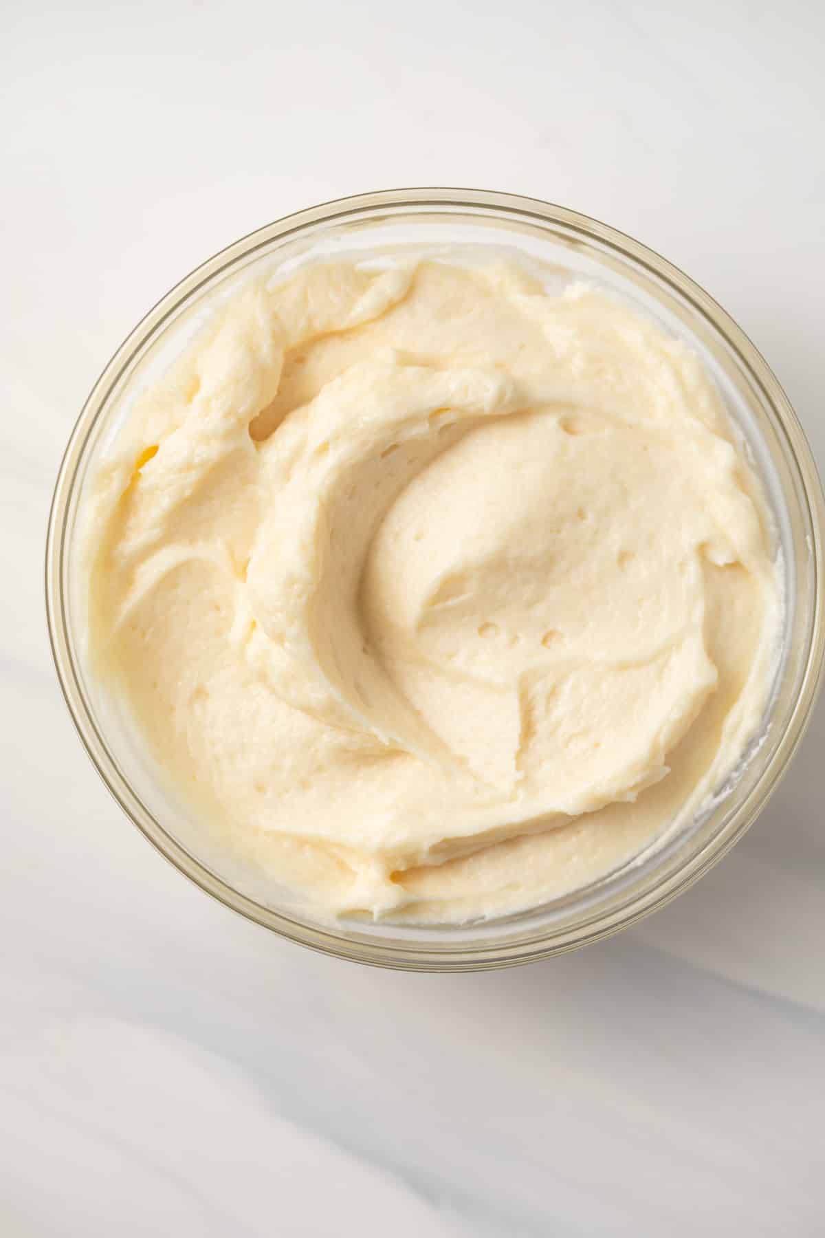 Close up of boiled frosting in glass bowl.