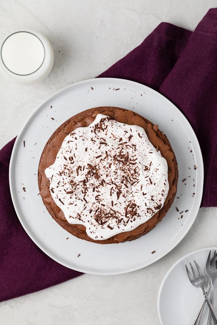 overhead of chocolate cake without flour topped with whipped cream and chocolate shavings