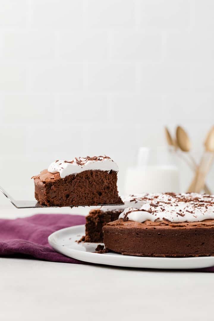 slice of flourless chocolate cake on a cake server