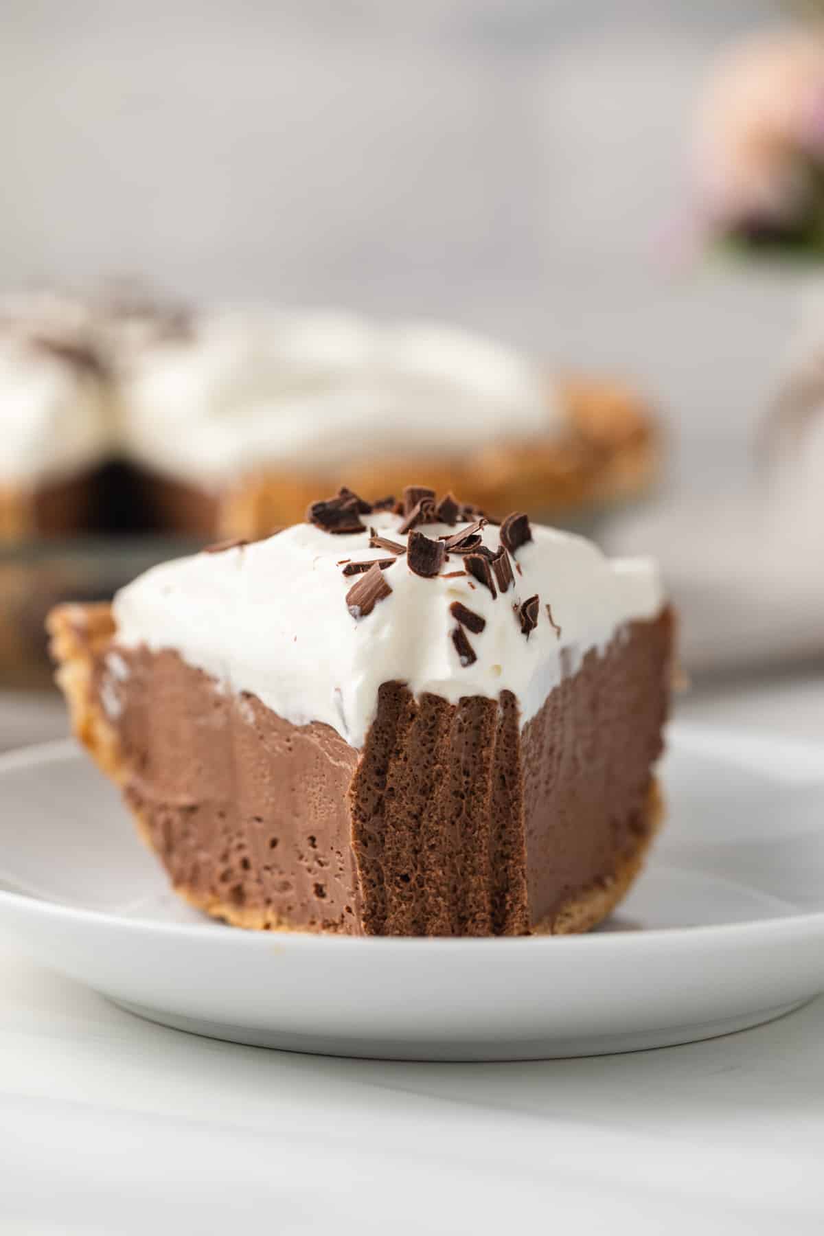 Slice of French silk pie with a bite taken out.
