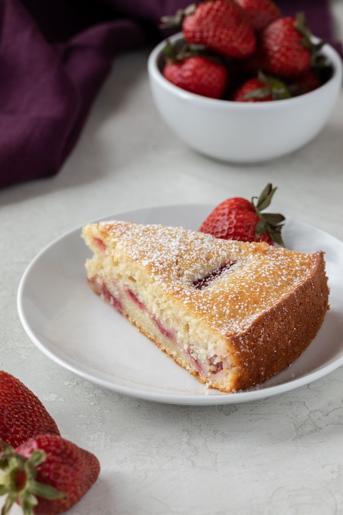 slice of fresh strawberry cake on white plate