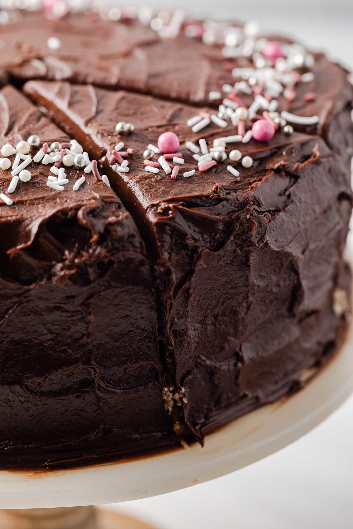 Close up of fudge frosting on a sliced cake.