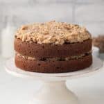 Side view of German chocolate cake on cake stand.