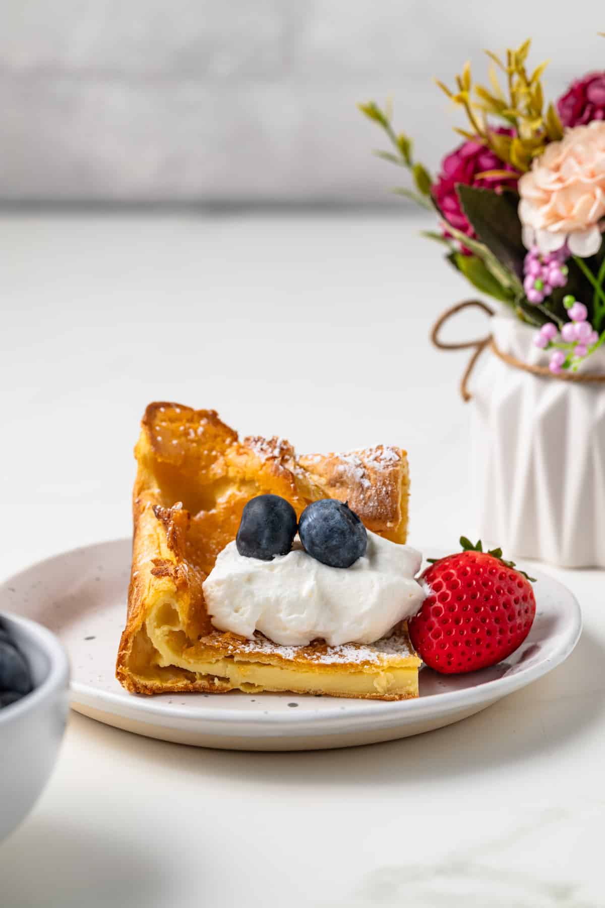 Slice of German pancake on plate.