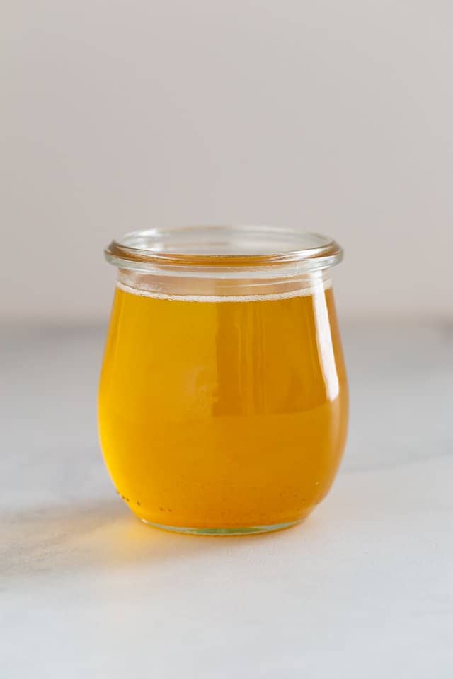 side view of ghee in a glass jar
