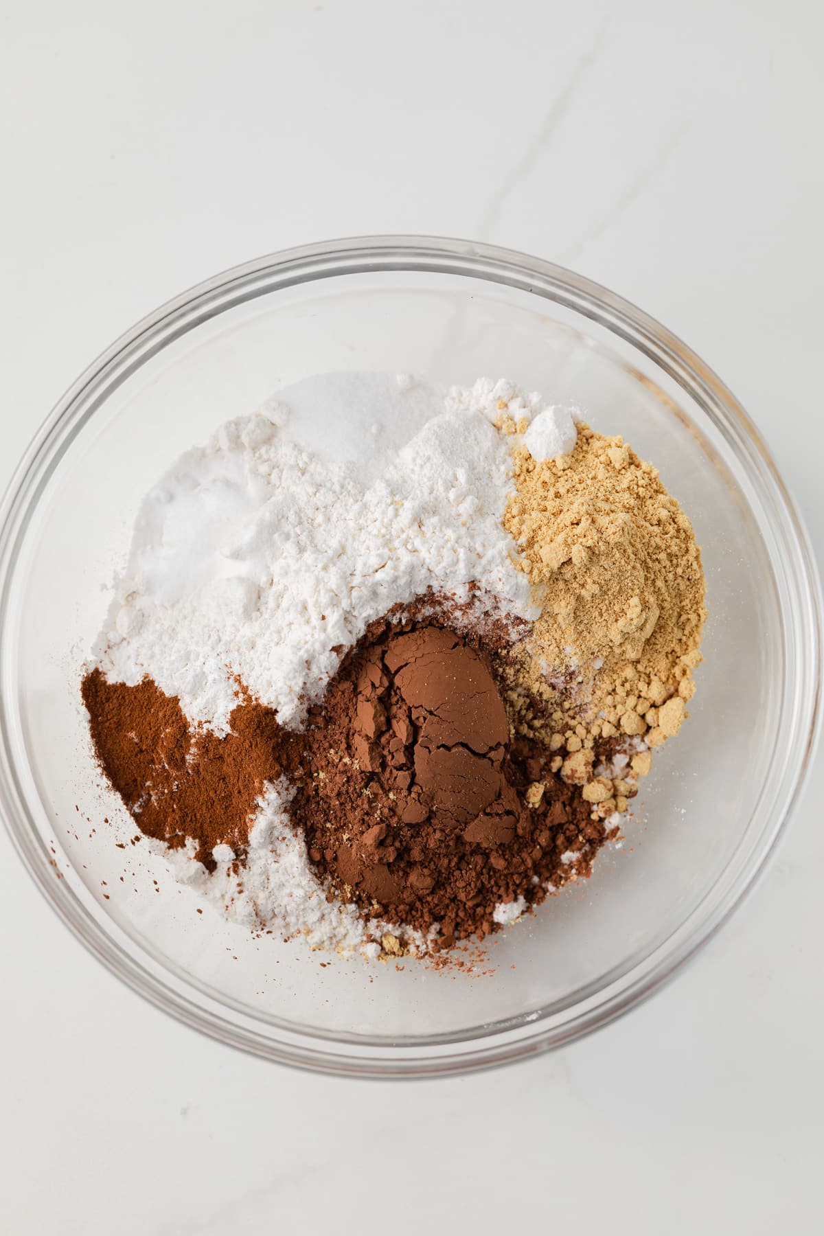Dry ingredients combined in glass bowl.