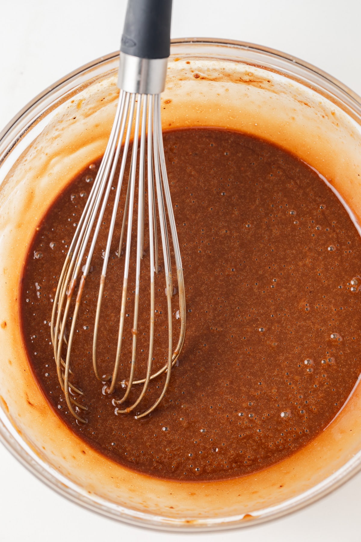 Gingerbread cake batter in glass bowl.