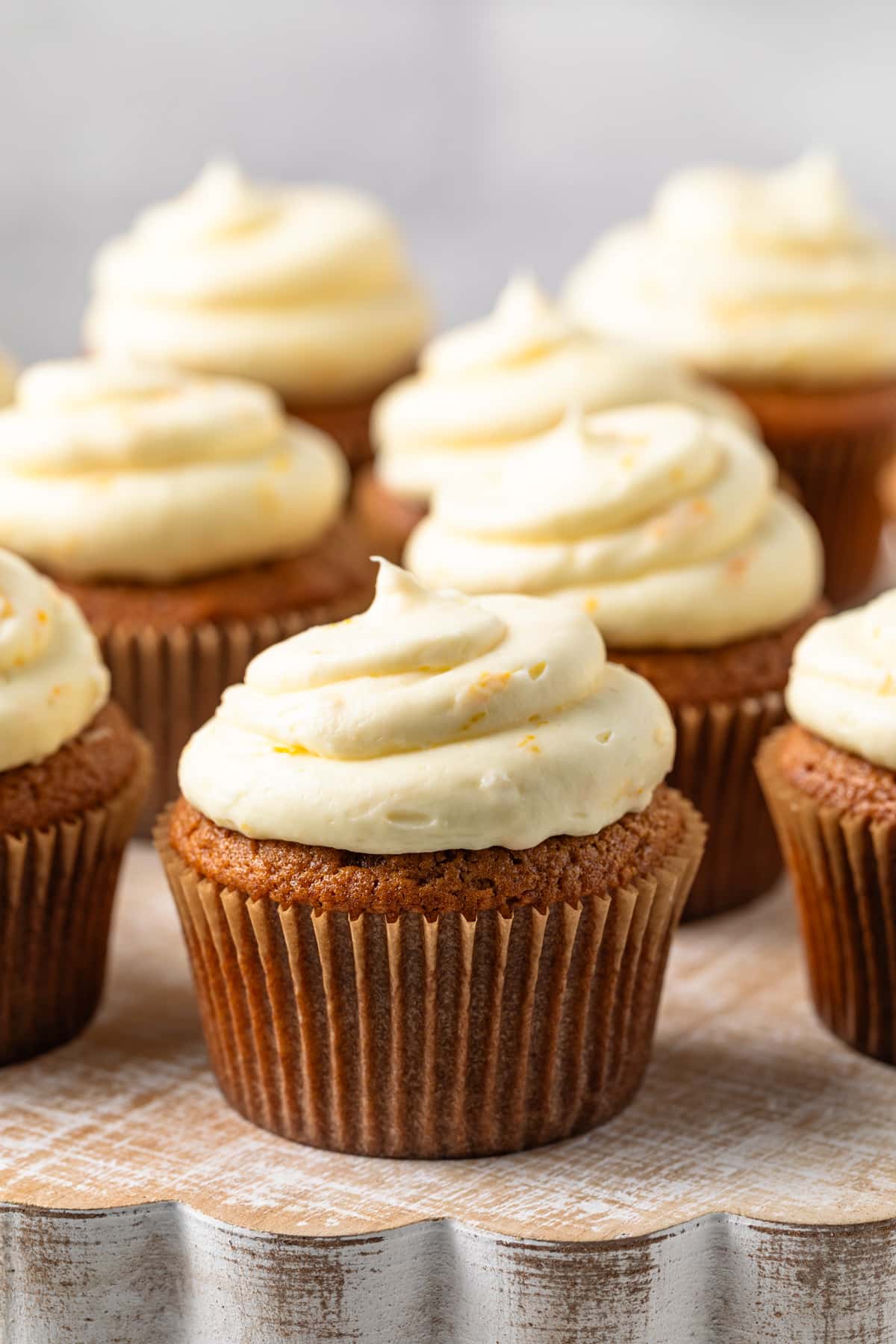 Gingerbread cupcakes on a wooden cake stand.