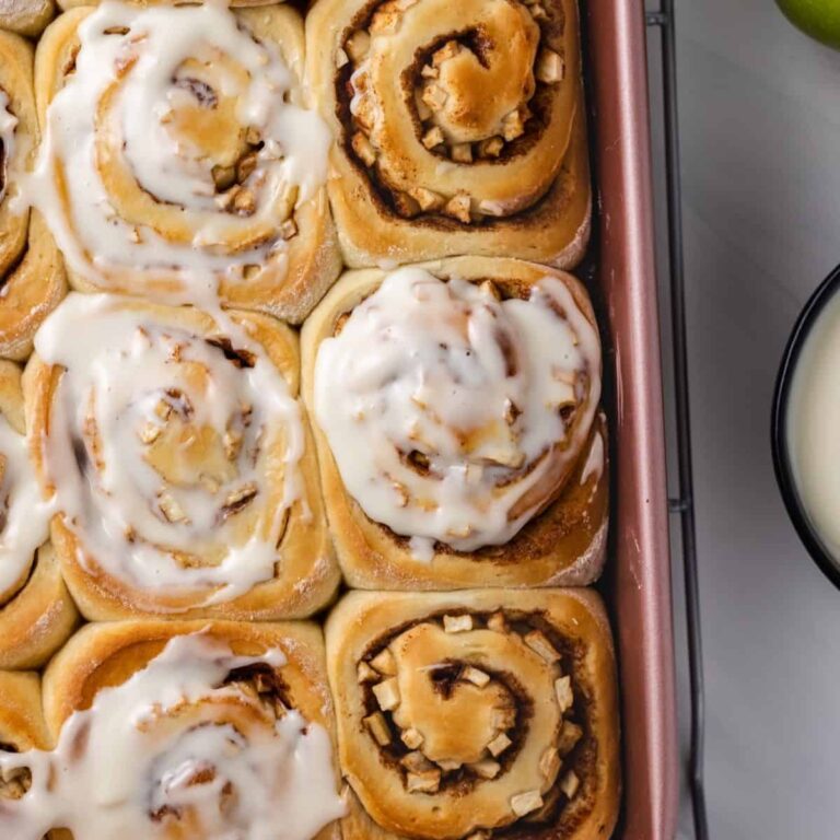 Apple cinnamon buns with cream cheese glaze in a baking dish