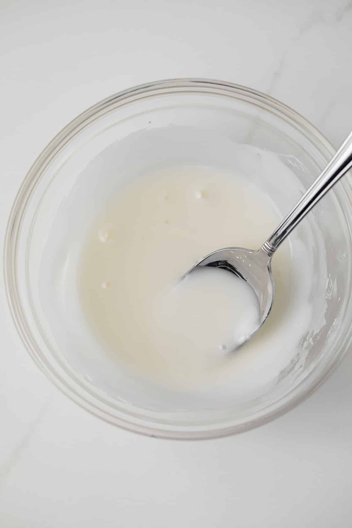 Lemon glaze in glass bowl.