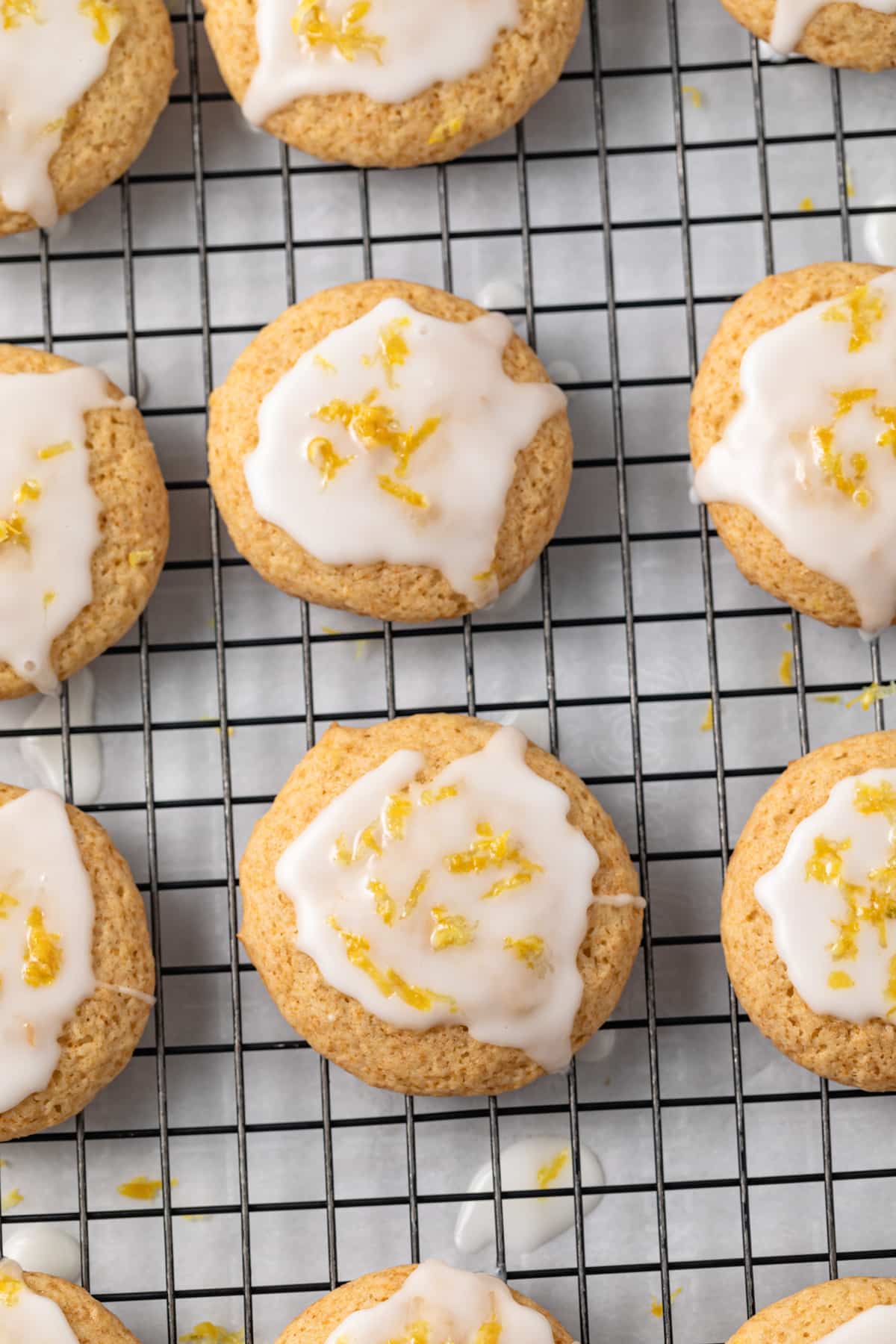 Lemon cookies with lemon glaze on wire rack.