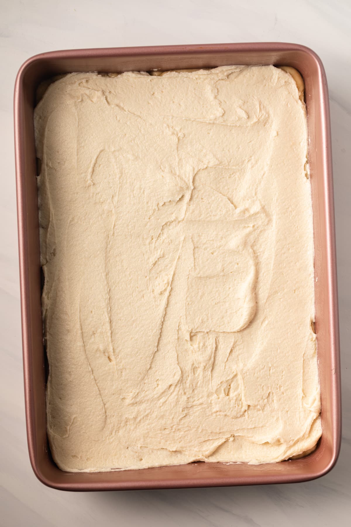 Unbaked gooey cake in a cake pan.
