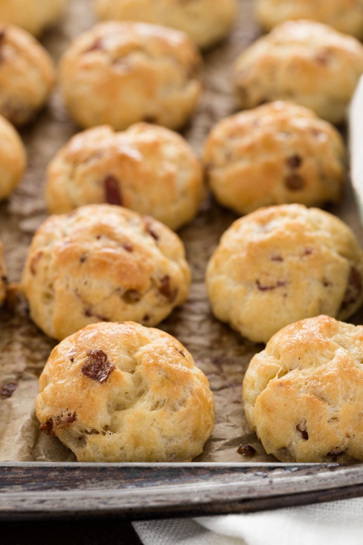 front closeup of Bacon Garlic Gougères lined on a baking sheet.