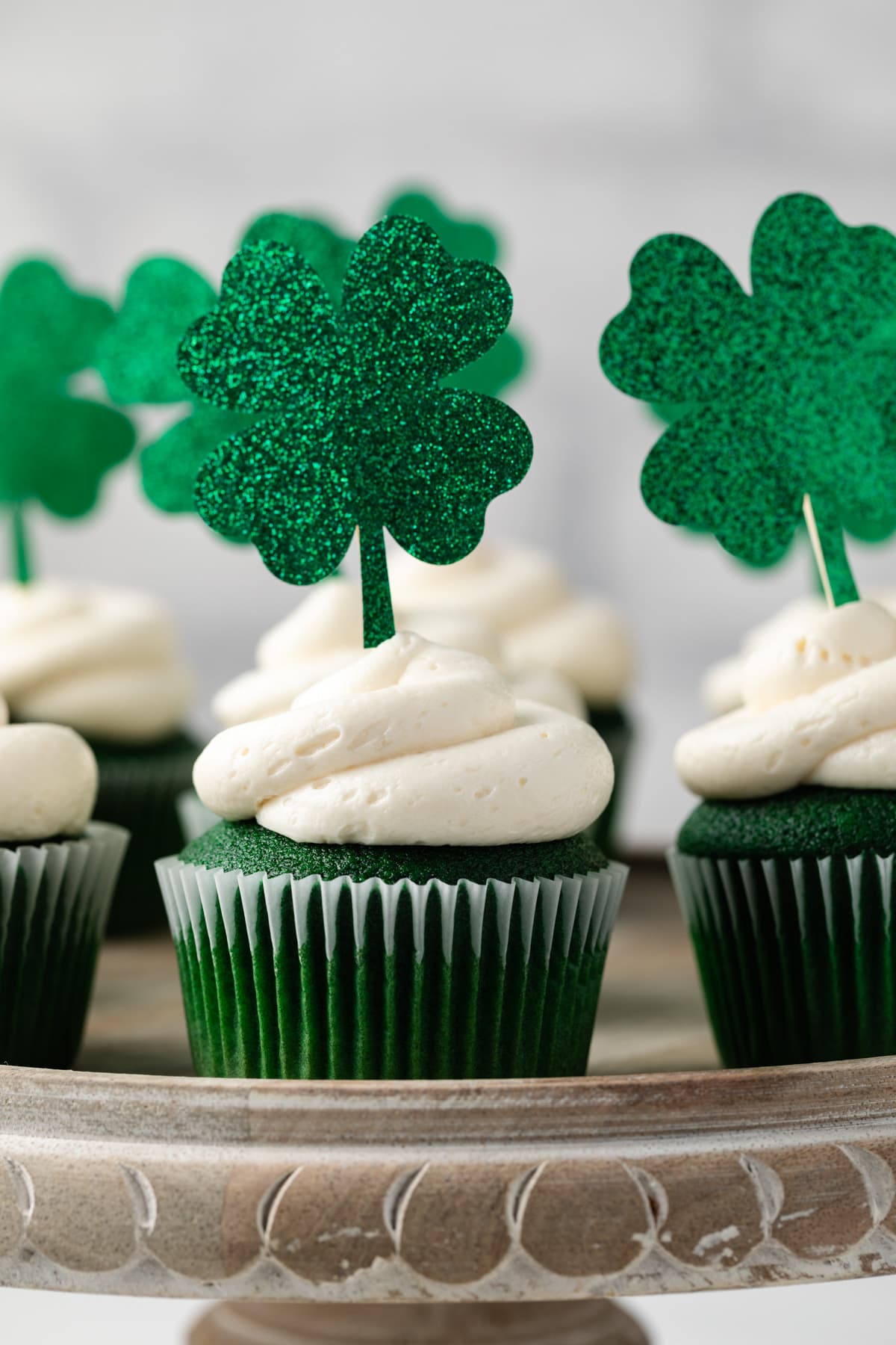 Green velvet cupcakes on cake stand.