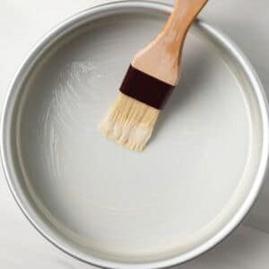 Cake release spread in a cake pan with pastry brush.