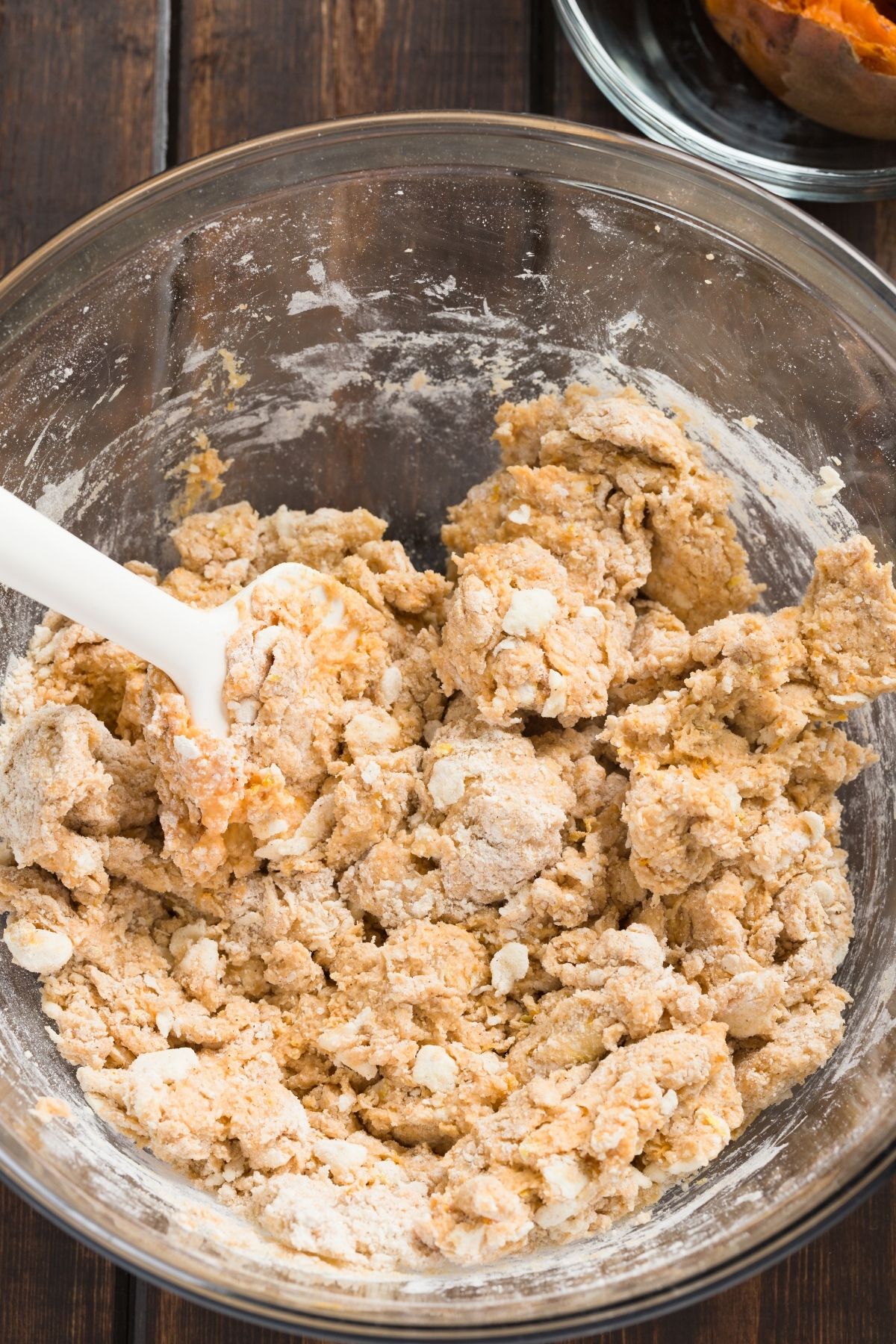 Shaggy sweet potato scone dough in a glass mixing bowl