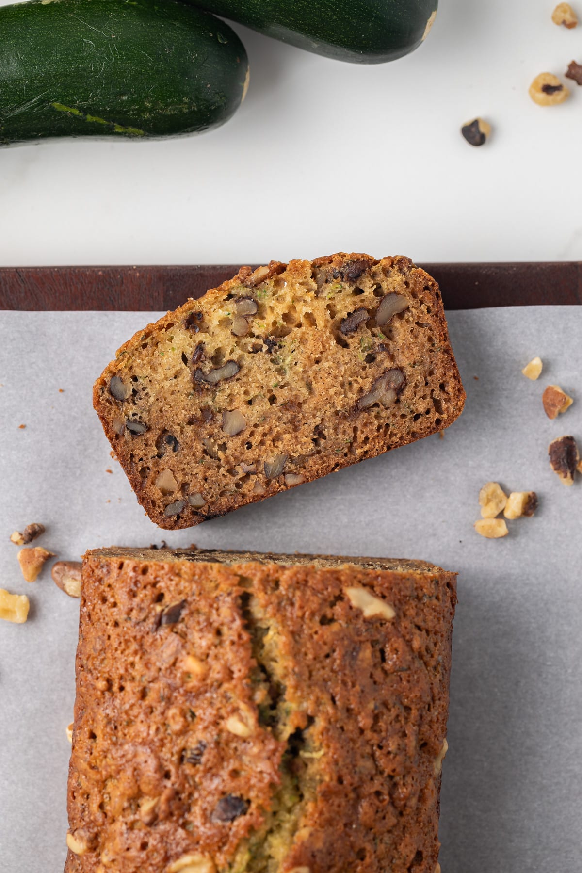 Overhead view of honey nut zucchini bread with slice taken off.