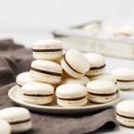 gorgeous macarons with chocolate filling on a white plate