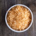 microwave toasted coconut in a white bowl