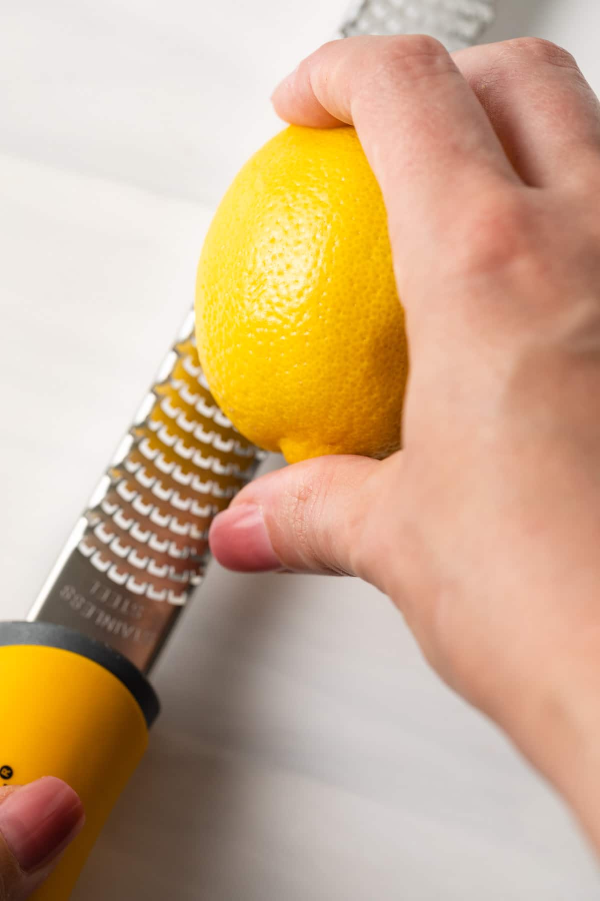 Zesting a lemon with a microplane.