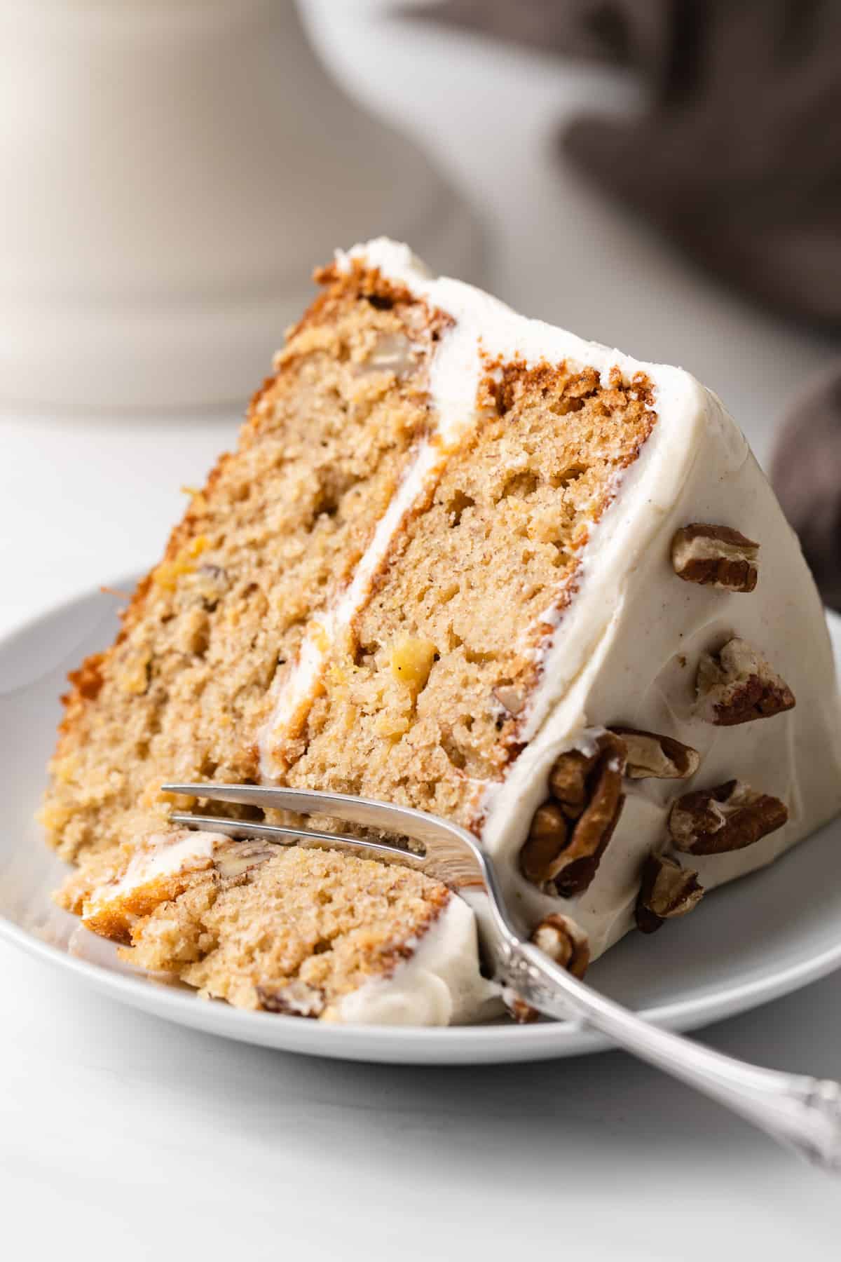 slice of hummingbird cake with fork taking a bite out