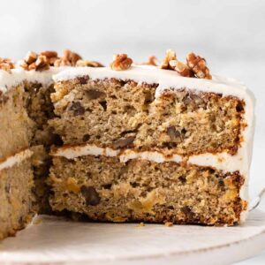 side view of hummingbird cake with slice taken out so the inside of cake is visible