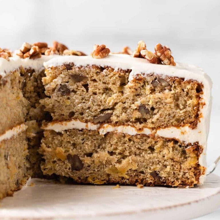 side view of hummingbird cake with slice taken out so the inside of cake is visible