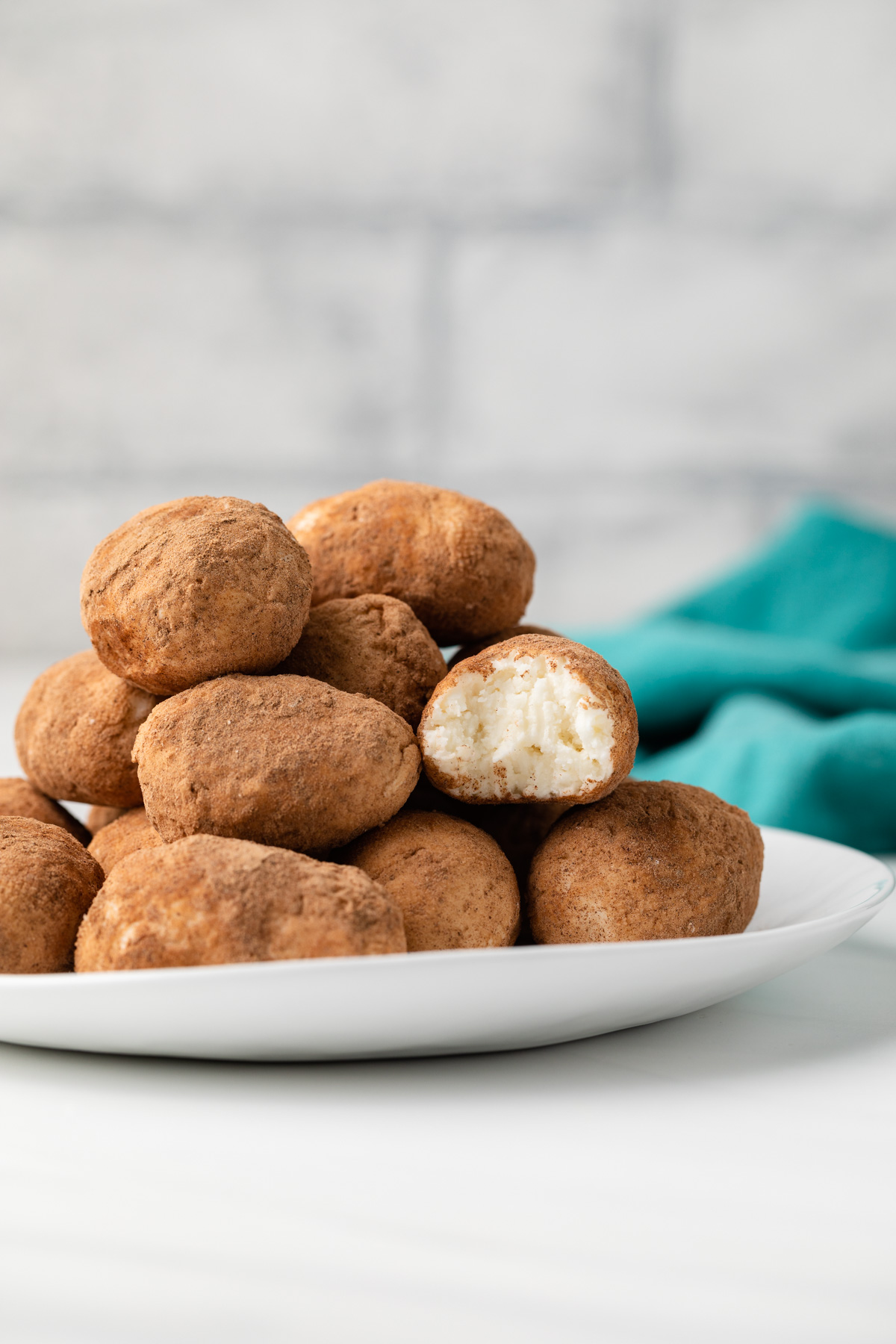 Side view of potato candy on a white plate.