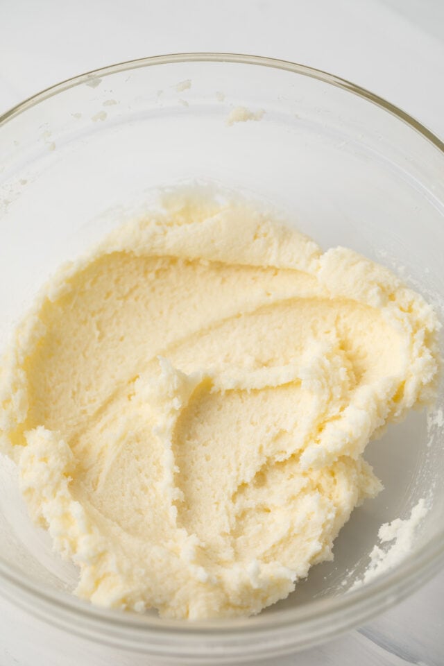 Creamed butter and sugar in glass bowl.