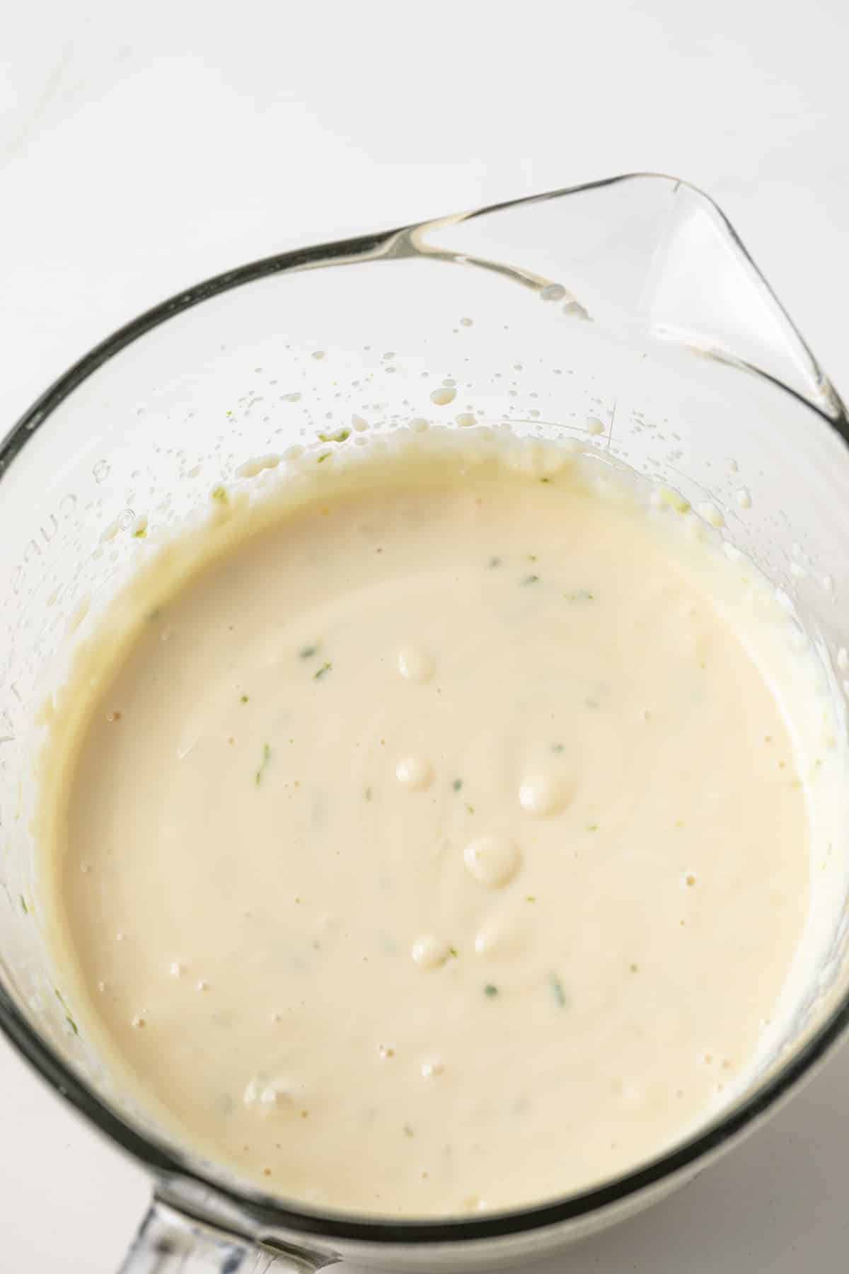 Batter for key lime bars in a glass pan.