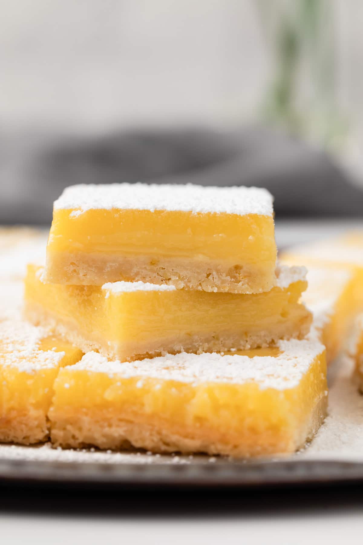 lemon bars stacked three high on a baking tray