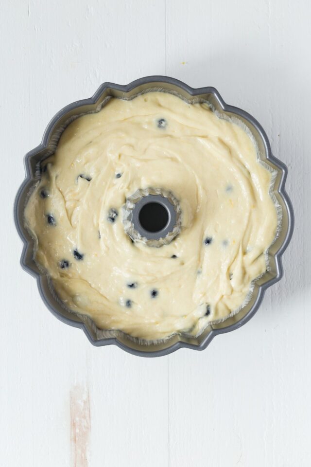 Lemon blueberry bundt cake batter in pan.
