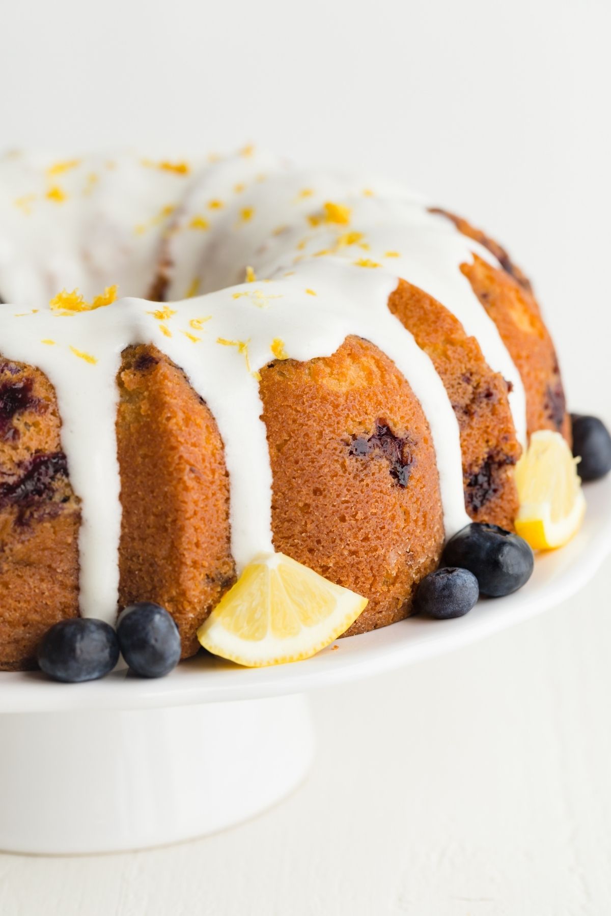 lemon blueberry bundt cake on a white cake stand