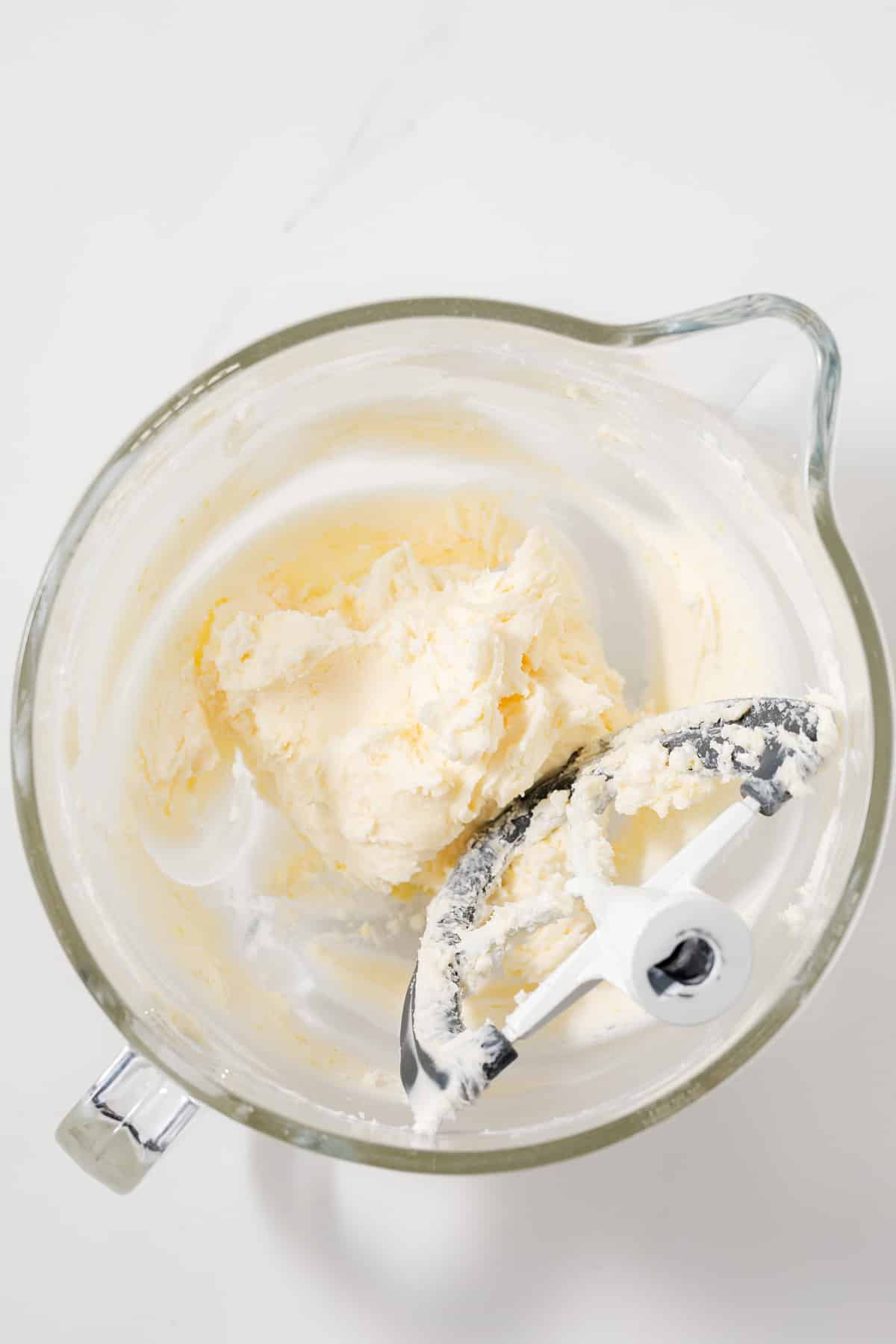 Butter and sugar creamed in glass bowl.