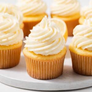 Side view of cupcakes topped with lemon buttercream frosting.