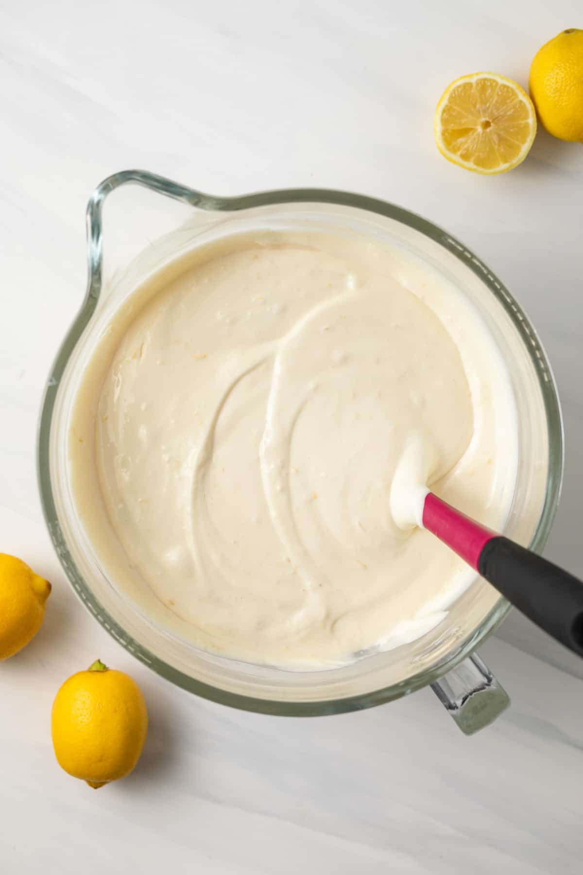 Lemon cheesecake batter in glass bowl.