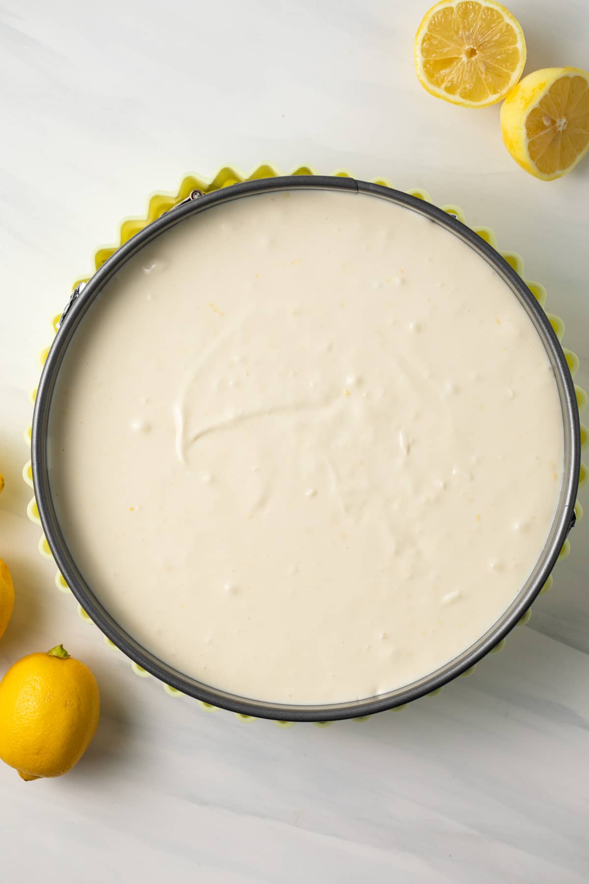 Unbaked lemon cheesecake in pan.