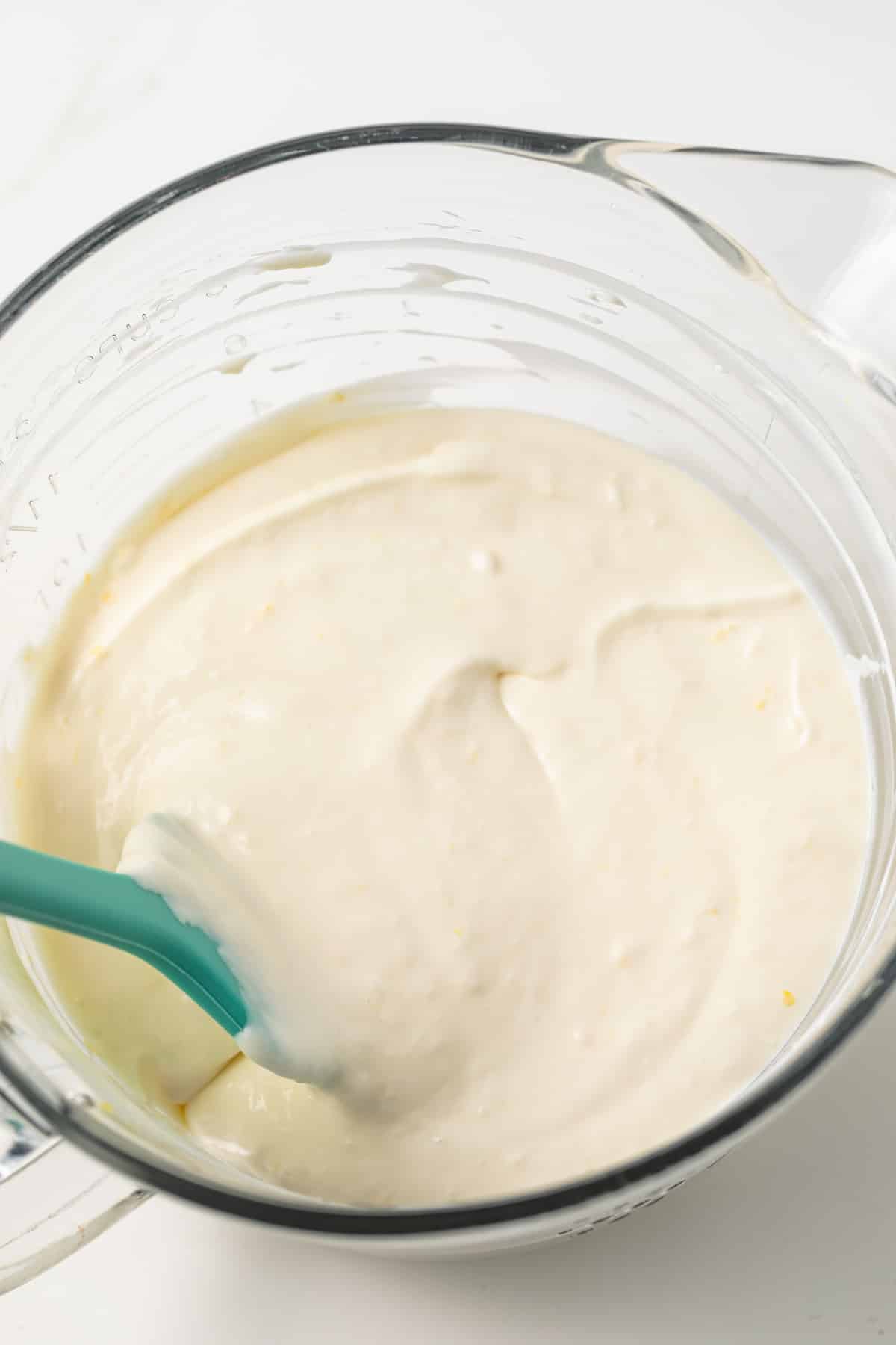 Lemon cheesecake filling in a glass bowl.