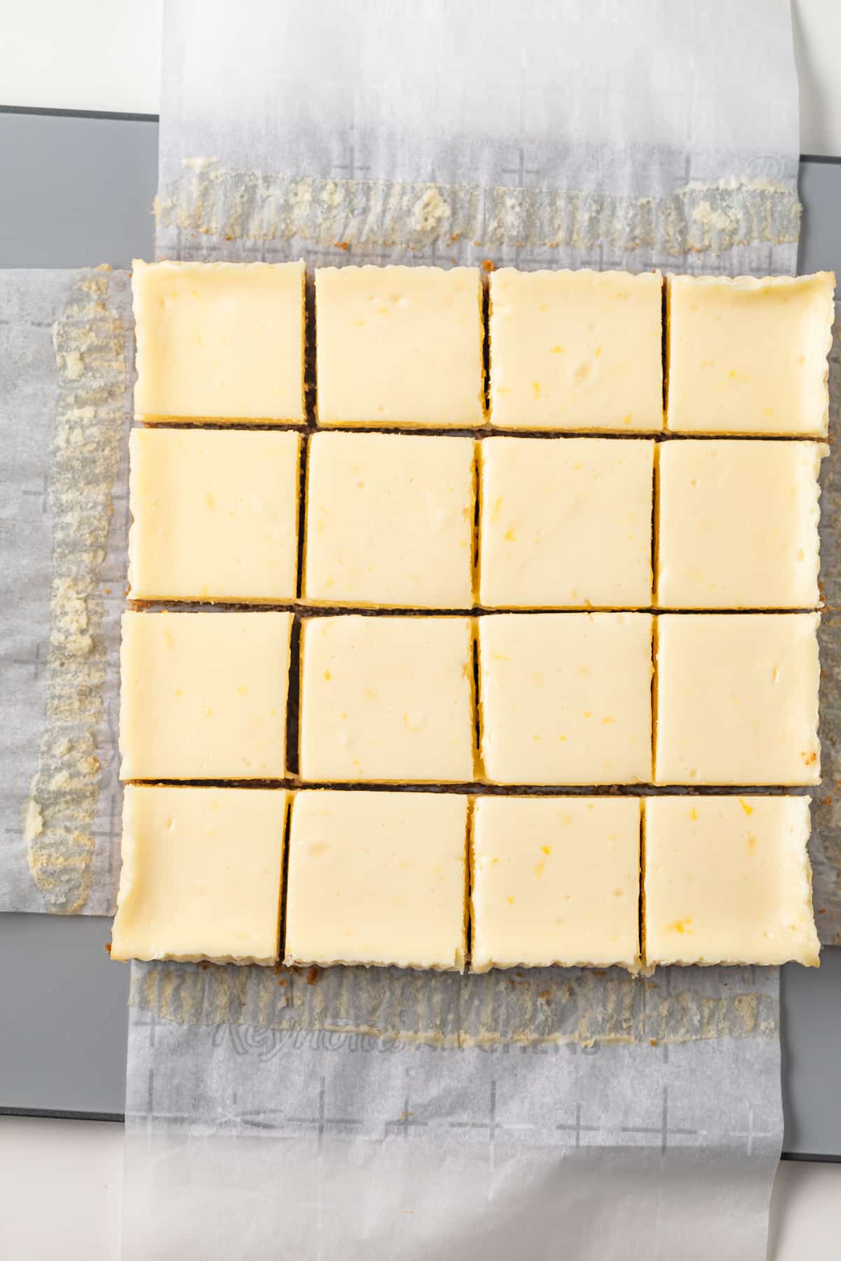 Overhead of sliced lemon cheesecake bars.