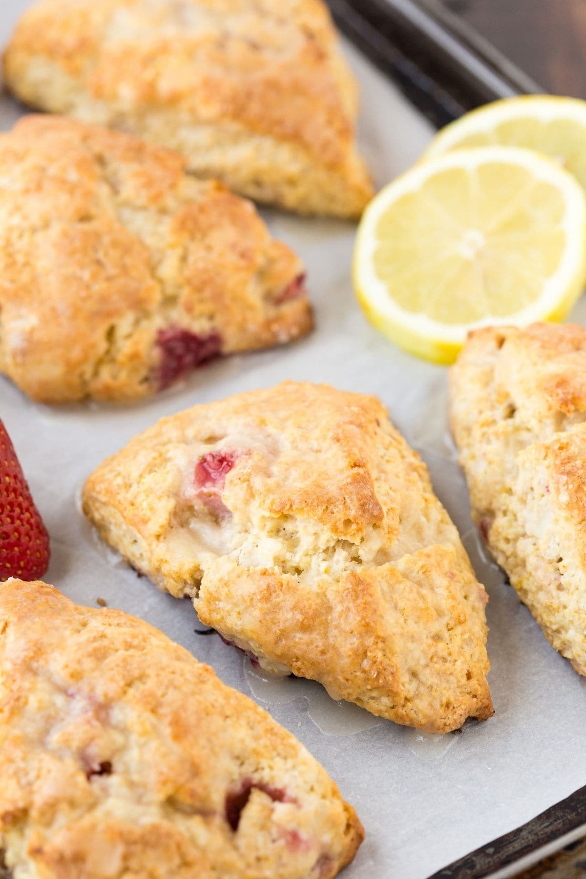Lemon Cream Cheese Scones on a baking sheet lined with white parchment paper.