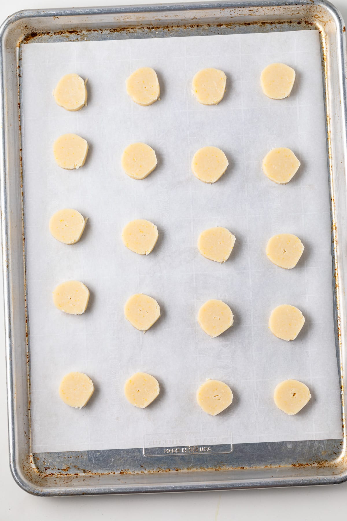 Unbaked lemon shortbread cookies on a sheetpan.