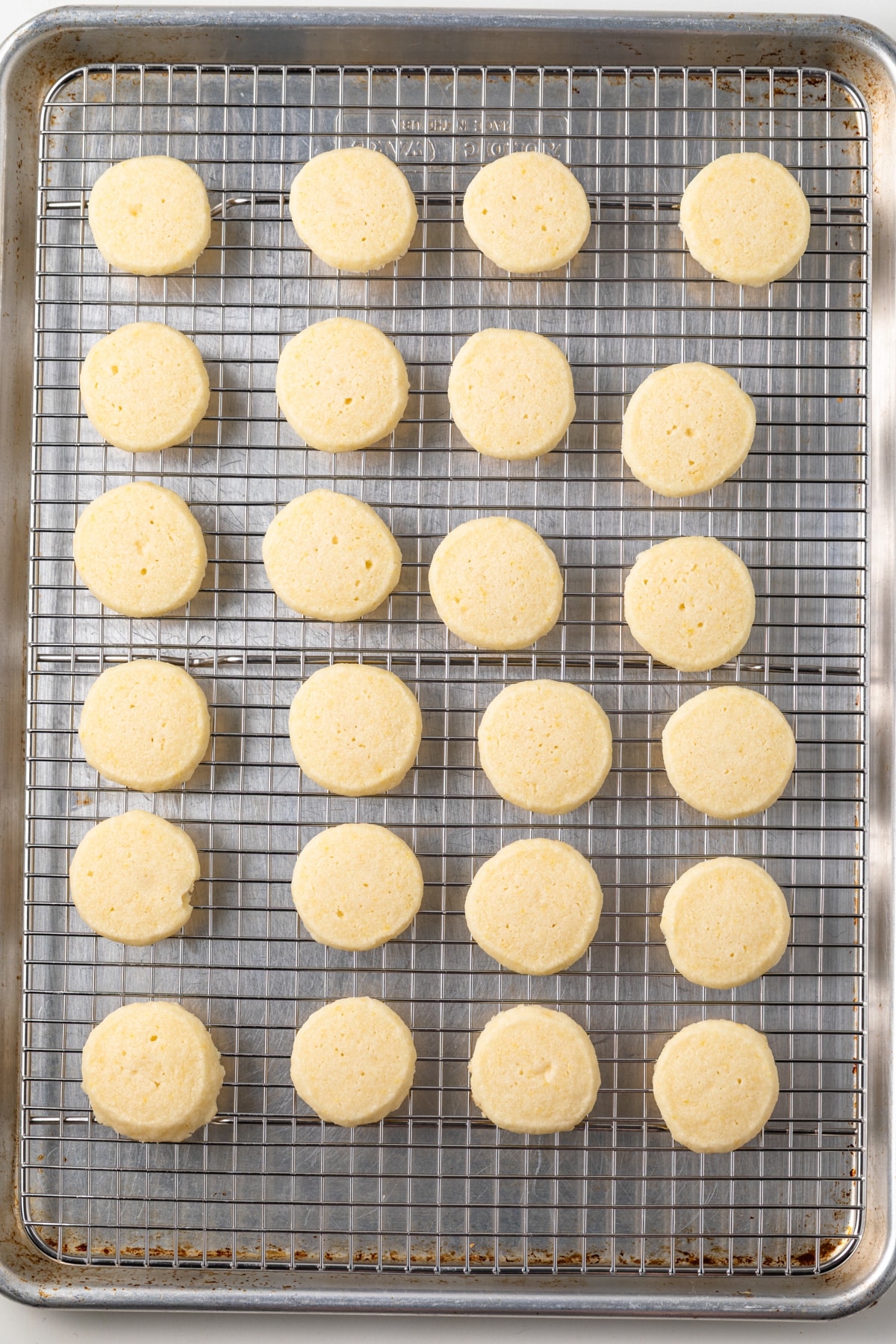 Baked lemon shortbread cookies on a wire rack.