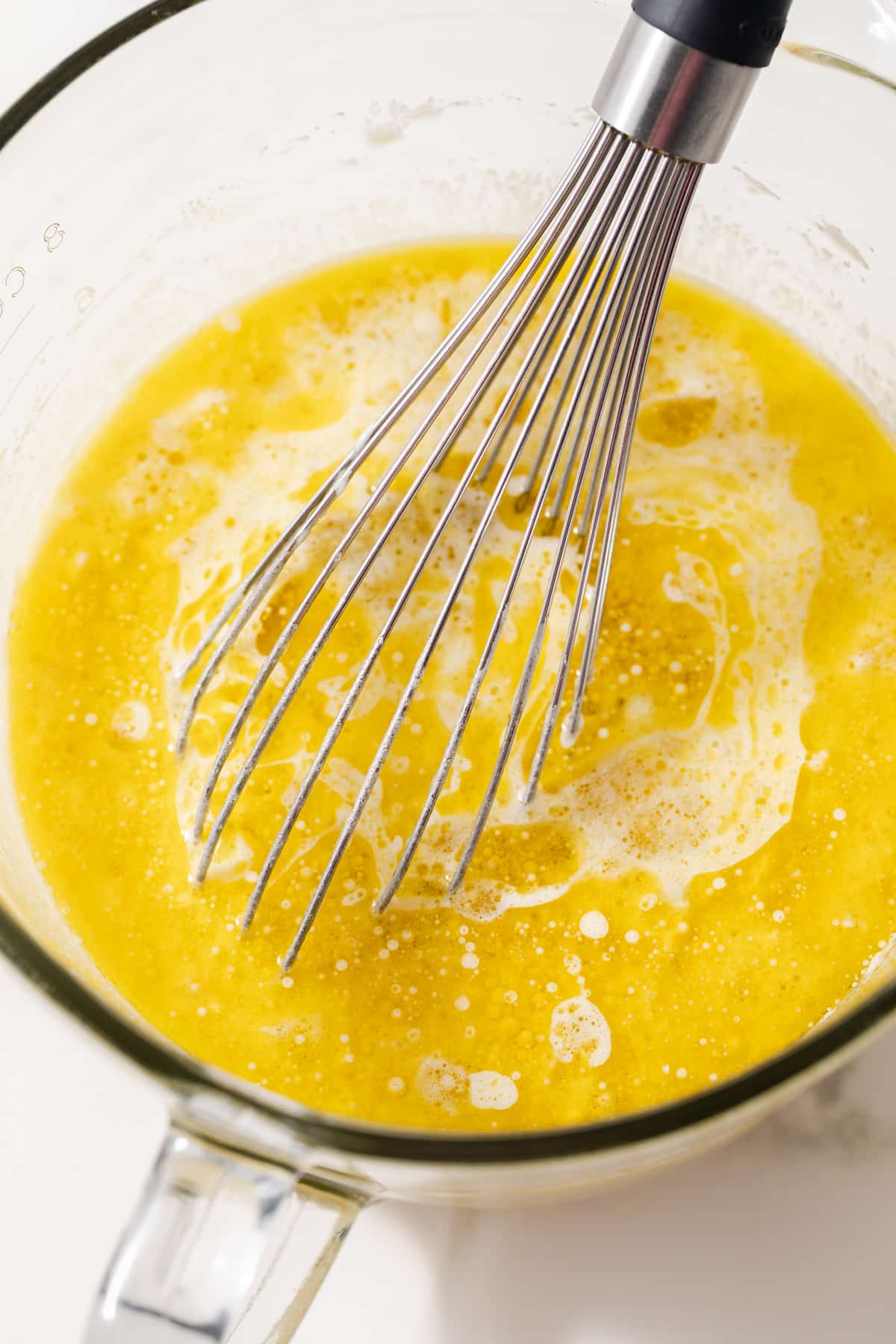 Wet ingredients combined in glass bowl.