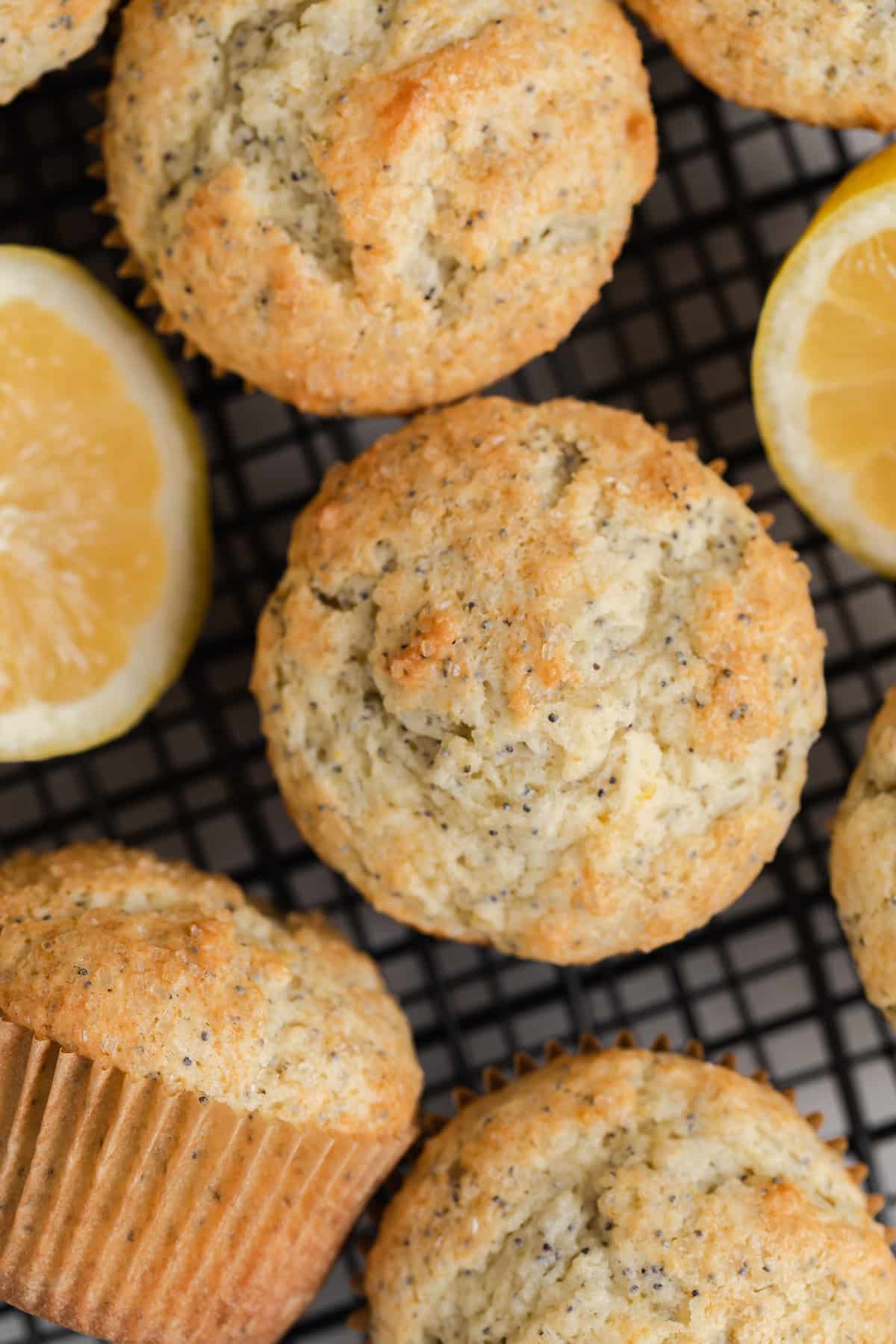 Overhead of lemon poppy seed muffins on wire rack.