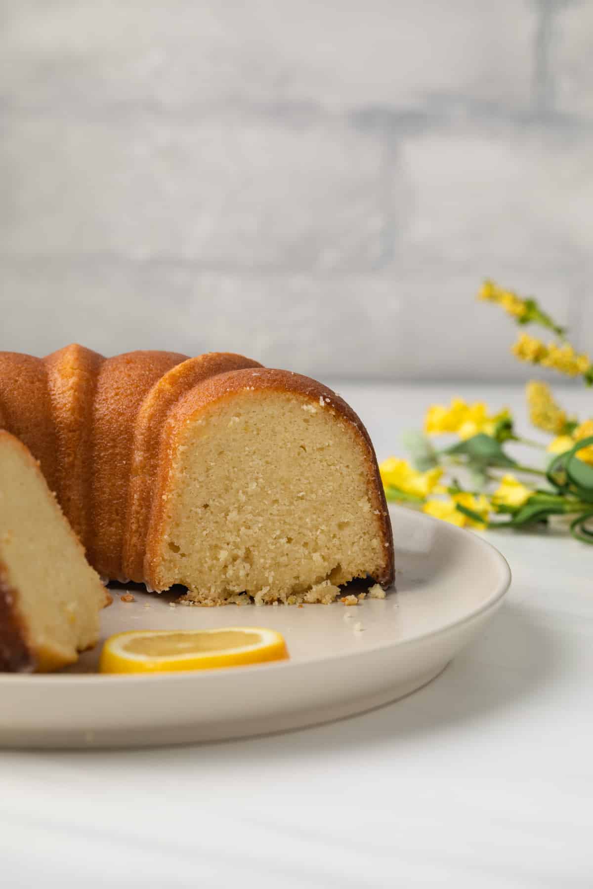 Side view of lemon pound cake with slices taken out.