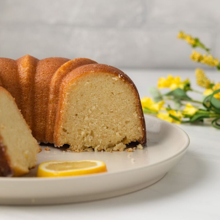Side view of lemon pound cake with slices taken out.