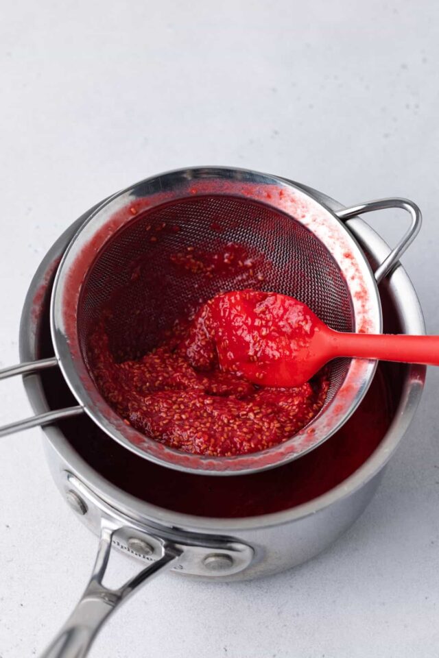 Raspberry puree in a mesh sieve