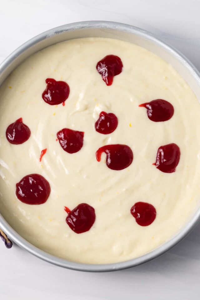 Lemon cake batter with drops of raspberry jam