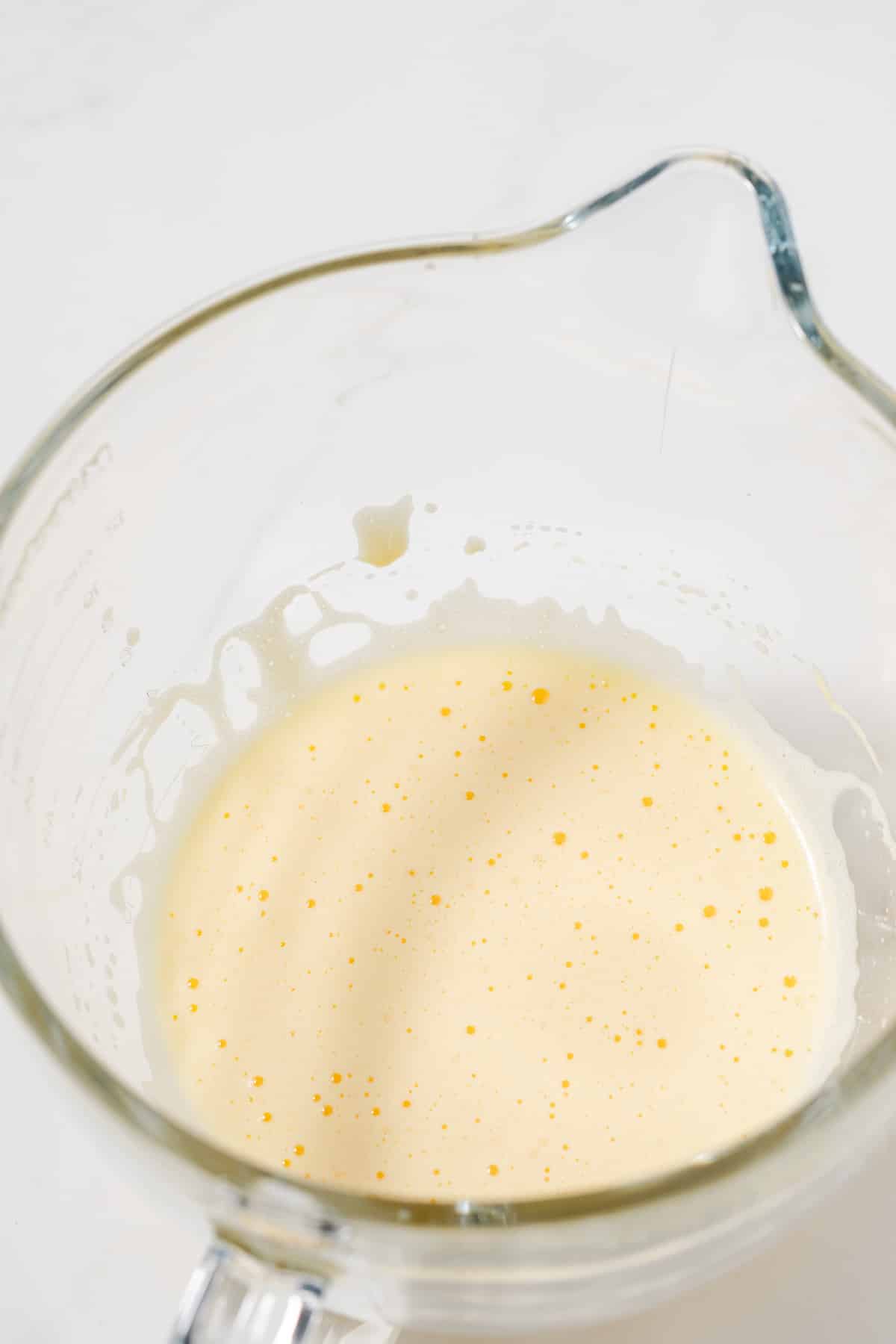 Frothy eggs in glass bowl.
